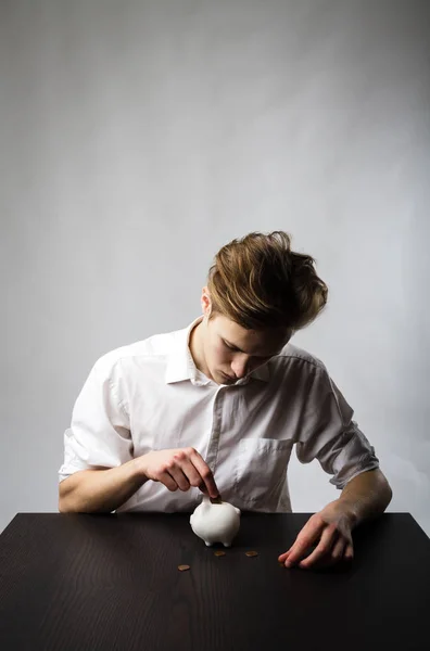 Young man and piggy bank. — Stock Photo, Image