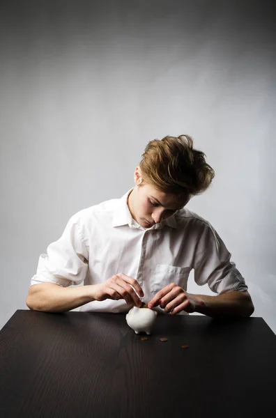 Young man and piggy bank. — Stock Photo, Image