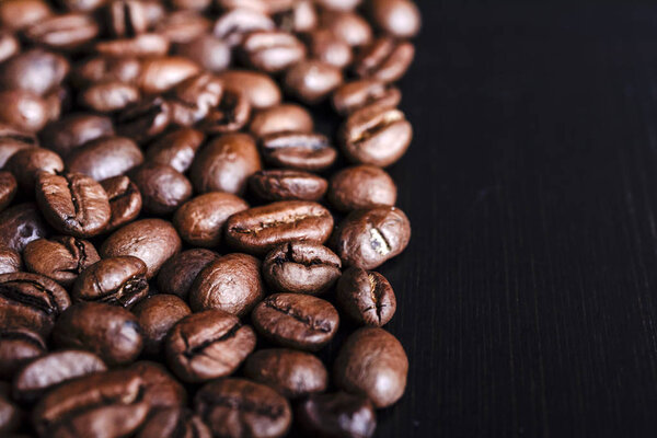 Coffee beans on wooden background.