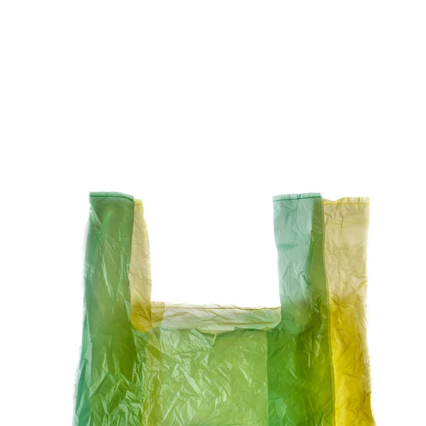 Žluté a zelené plastové nákupní tašky na bílém. — Stock fotografie