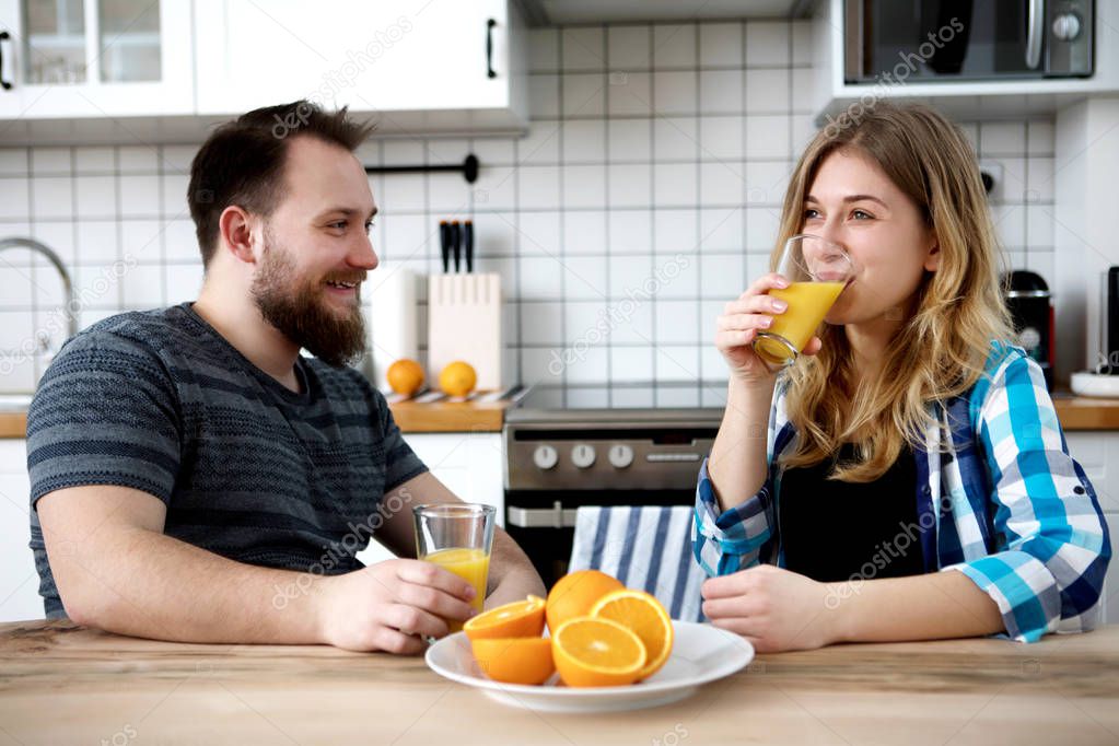 Couple drinking orange juice