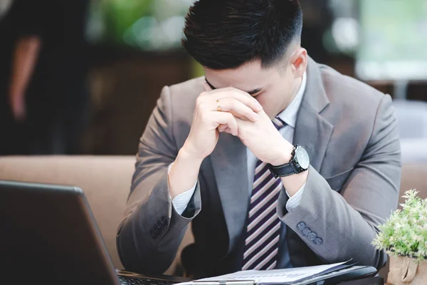 Young employee looking at computer monitor during working day in office