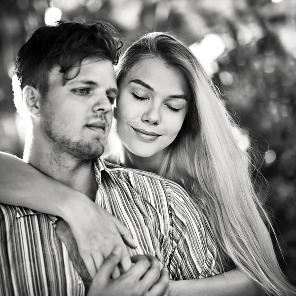 Black and white shot of a cute couple in love. Woman in love .