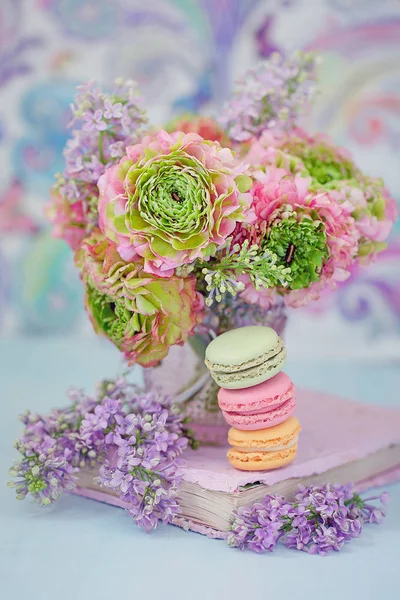 Beautiful bouquet of spring flowers in a vase on the table. Lovely bunch of flowers .Blue background.Pastel tonality.