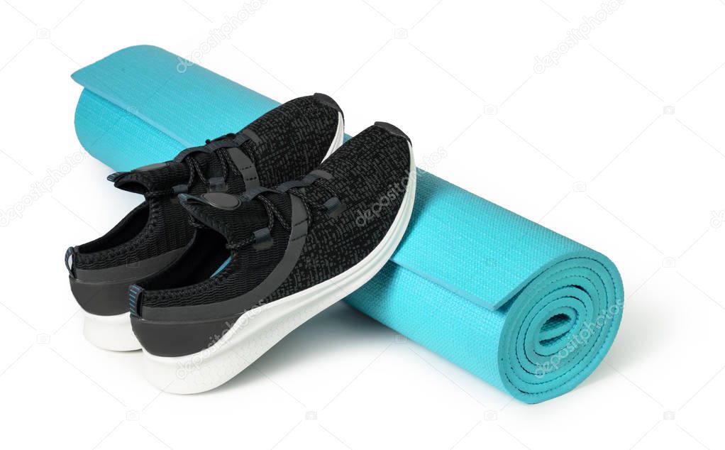 Sport shoes and yoga mat 
