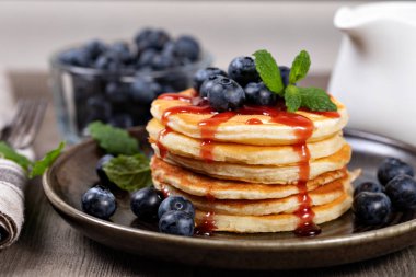 Pancakes with blueberries and syrup clipart