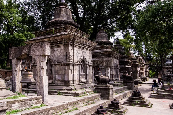 Close up of one old stone sacred building, inline with other behind. Pashupatinath Temple in Kathmandu, Nepal.