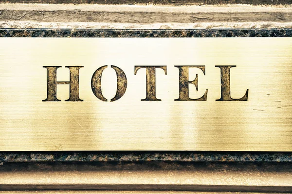 close-up of shiny golden hotel signboard