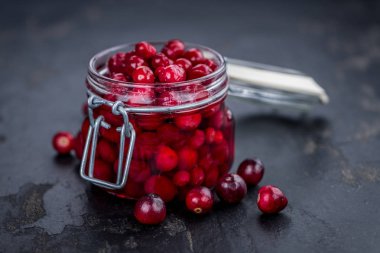 Fresh made Cranberries (preserved) on a slate slab (close-up sho clipart