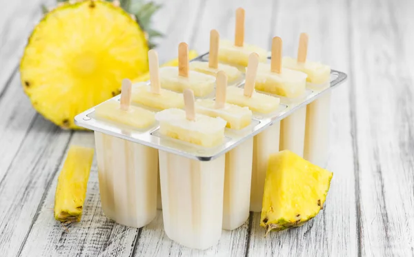 Wooden table with Pineapple Pipsicles (selective focus) — Stock Photo, Image