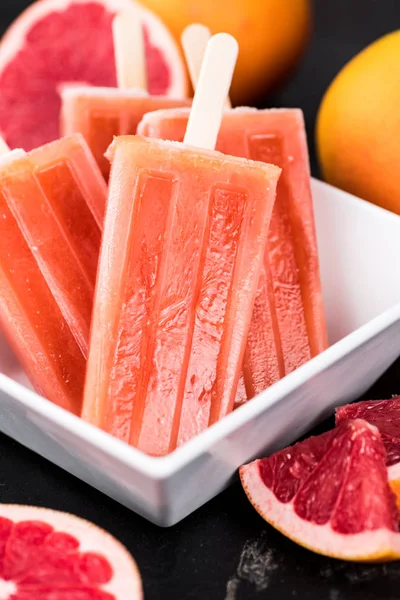 Slate slab with fresh Grapefruit Popsicles (selective focus) — Stock Photo, Image