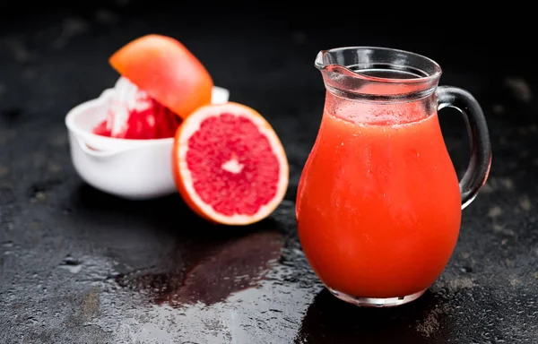 Schieferplatte mit frisch gepresstem Grapefruitsaft — Stockfoto