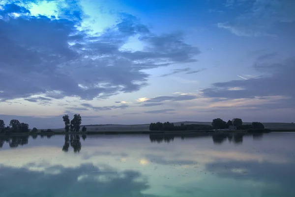 Blue evening clouds over a calm lake