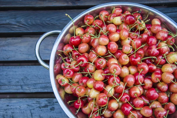 Yellow red cherries with stems in a round bowl