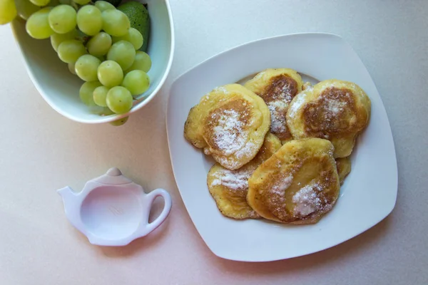 Traditional Polish pancakes on a plate and green grapes — Stock Photo, Image