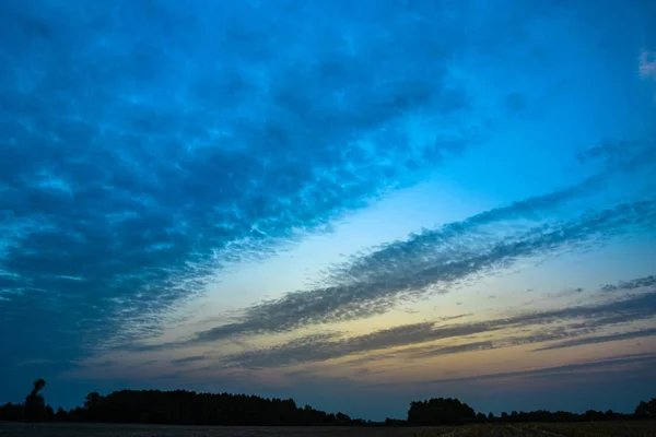 Stretched evening clouds after sunset