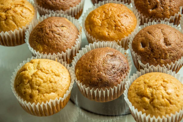 Homemade brown muffins in paper molds — Stock Photo, Image