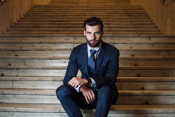 スタイリッシュなビジネスマン 屋外の階段に座ってカメラ目線ハンサムな若い男の肖像 — ストック写真