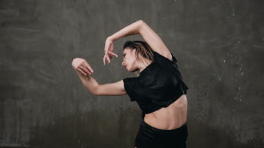 Güzel bir ıslak kadın dansçı dramatik bir dans yağmur etkisi altında kapalı açık stüdyo ışık içinde gerçekleştirir. Su yağmur altında sahnede modern dans dansçı gerçekleştirir