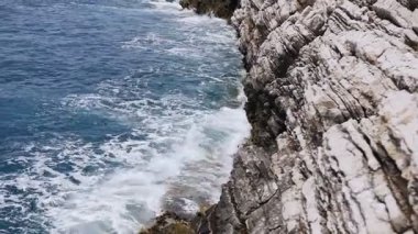 Petrovac, katmanlı rock cliff üzerinde sıçramasına güzel dalgalar. Karadağ, Adriyatik Denizi. Dalgalar deniz taş sıçramış