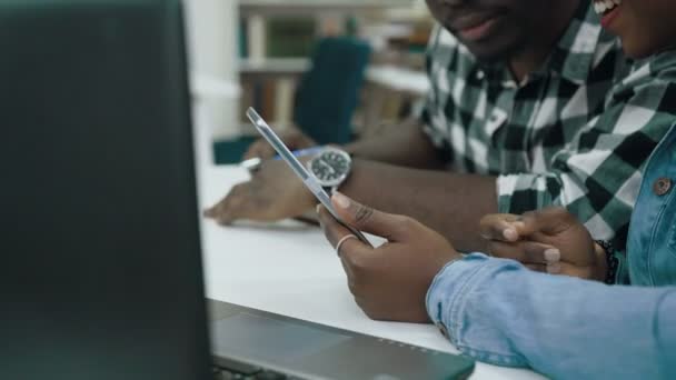 Primer plano de los estudiantes africanos usando tableta en la biblioteca . — Vídeos de Stock