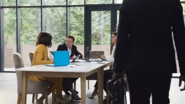 Afro Amerikalı işadamı girme office meslektaşları ile tokalaşırken Oda yapma toplantı evrak çantası ile resmi takım elbise giyiyor. Toplantı zamanı. Dolly vurdu