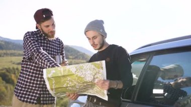 Dağ yürüyüşü için haritada alan araştırma iki hippi erkek.
