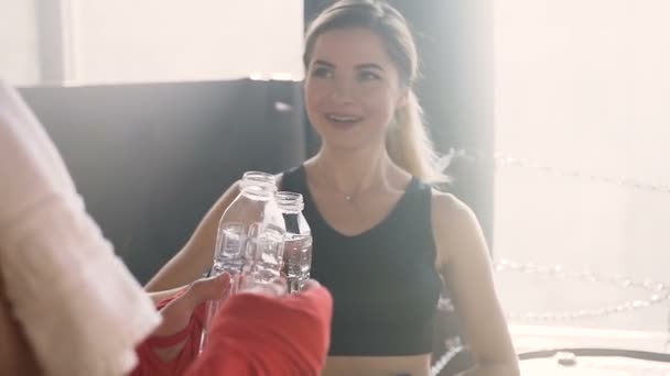 Portrait shot of male and female boxer drinking water after boxing training. — Stock Video