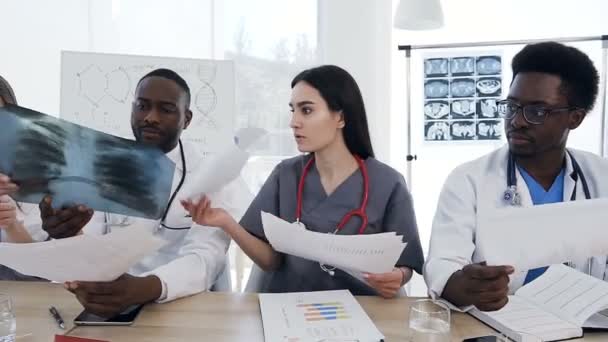 Dolly shot of team of doctors having a meeting in conference room in the modern hospital. — Stock Video