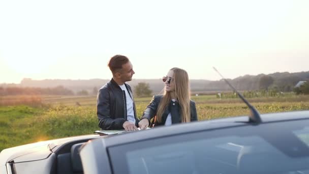 Joyeux jeune couple utilisant la carte pendant le voyage sur le cabriolet . — Video