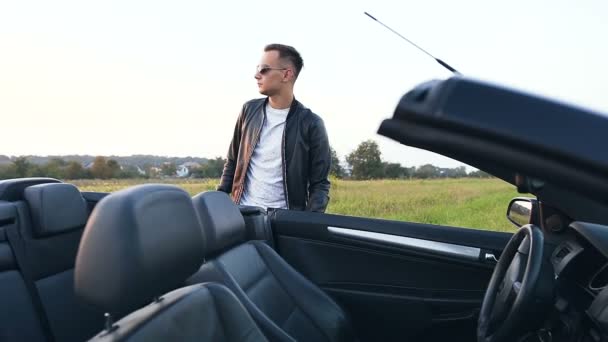 Confident caucasian man opening the door and sitting in cabriolet. — Stock Video