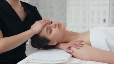 Masaj salonunda yüzüne masaj sırasında sevimli yakışıklı kadın.