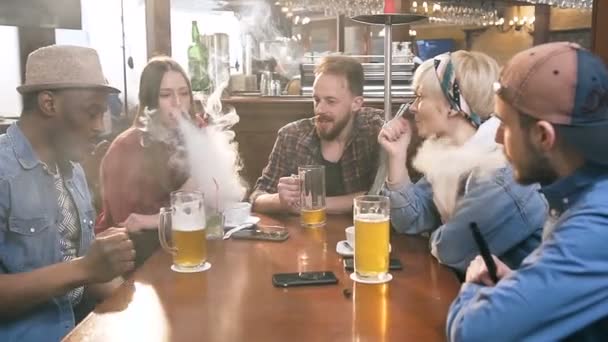 Empresa de jovens amigos hipster relaxando com shisha ou narguilé no bar . — Vídeo de Stock