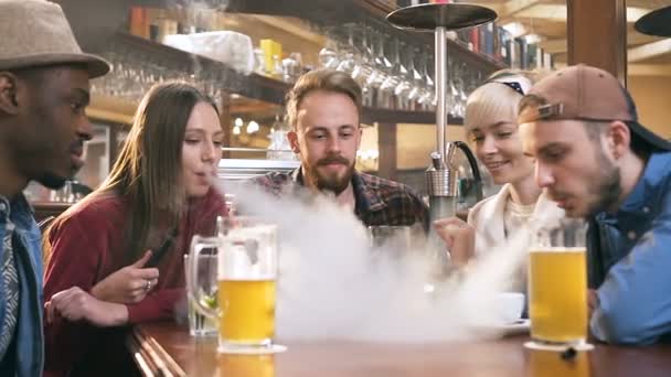 Skupina mladých přátel relaxačních s šishou nebo vodní dýmka v baru. — Stock video