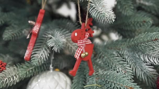 Primer plano del árbol de Navidad decorado con conos de pino plateado y juguetes de ciervos rojos — Vídeo de stock