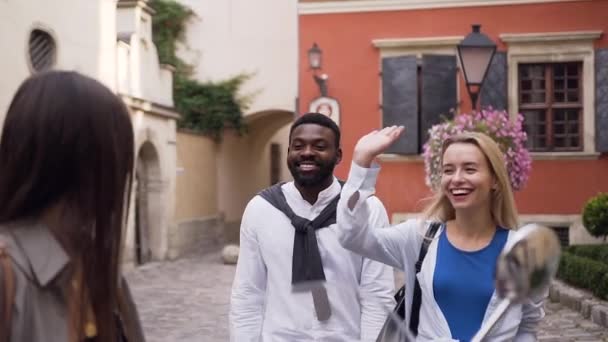 Simpáticos jóvenes amigos alegres dando chocar cinco en el patio urbano — Vídeo de stock