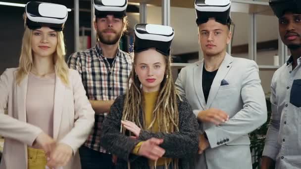 Positive likable smiling confident creative young team posing on camera in office room with crossed hands and special 3d glasses on heads — Stock Video