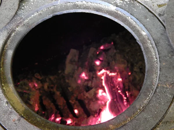 Traditional cast-iron stove brick oven tradition cooking on fire close-up rusty open — Stock Photo, Image