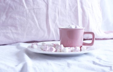Pembe seramik bardakta yatağında lokum olan sıcak kakao. Tatil ve yeni yıl kavramı. Pembe keten arka plan. Düz yatış, üst görünüm.