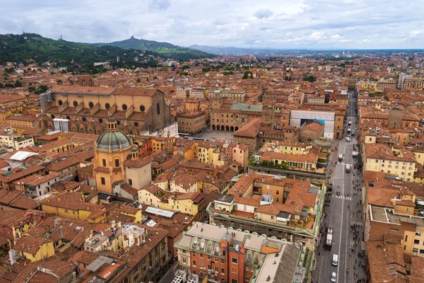 Top view from the tower Asinelli at Bologna, Italy. Panorama of the old city - red brick buildings, tiled roofs, Piazza Maggiore.