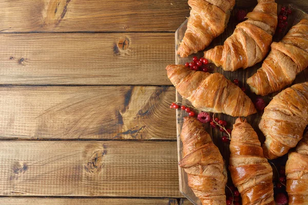 Croissants Con Bayas Sobre Fondo Madera —  Fotos de Stock