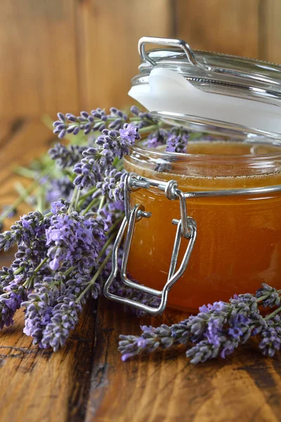 Natural organic lavender honey on a wooden background