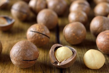 Macadamia nuts on a brown background