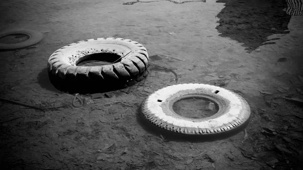 abandoned tire on the water sea or lake pond with black and white style color in indonesia