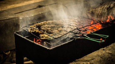 balık ızgara ile ateş ve kömür ve beyaz duman karimun jawa Endonezya sokak gıda