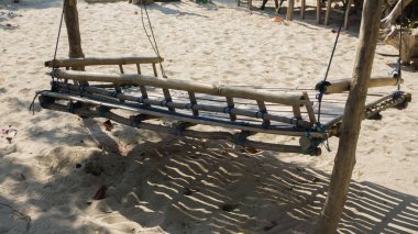 chairlift wood bamboo traditional for relax in holiday on the sand beach in karimun jawa indonesia clipart