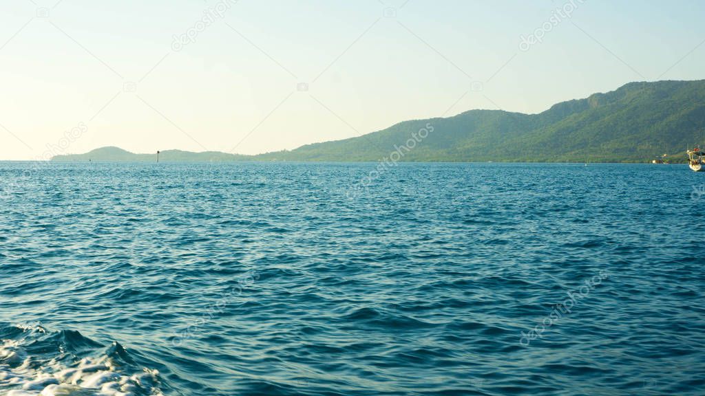 green island with dark blue sea in distance in karimun jawa indonesia