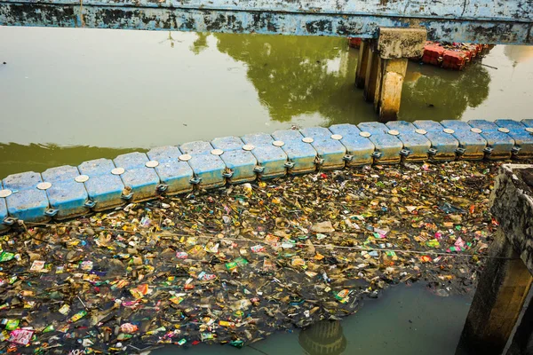 trash and garbage on the water and block water flow in indonesia