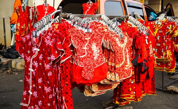 a kids chinese clothes sell on the store with red color in street side in indonesia