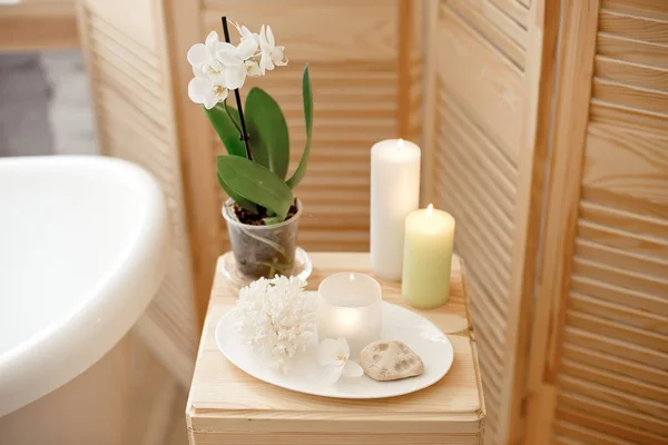 set for spa procedure and bathroom procedures, burning candles and flower